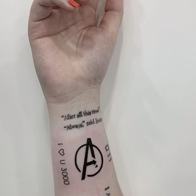 Black A logo avengers tattoo on upper left arm